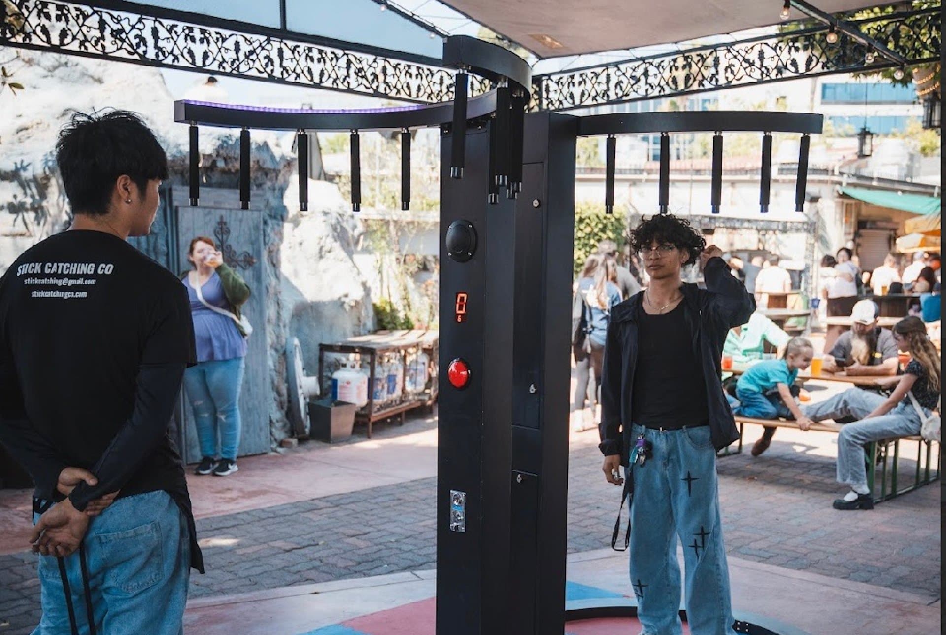 Stick Catching Co. machine at a live outdoor event